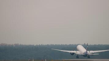 Rear view, passenger plane speeding up and taking off. Flight departure video