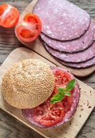 Sandwich with salami and tomatoes photo