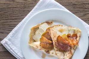 Crepes with brie and caramelized slices of apple photo