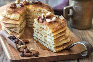 Stack of pancakes with butter and maple syrup photo