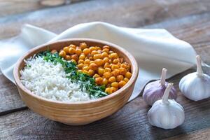 Bowl of chickpea curry with white rice and fresh cilantro photo