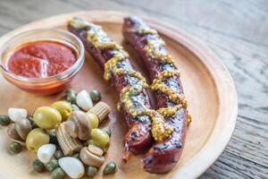 Grilled sausages with marinated vegetables photo