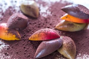 Luxury chocolate candies with cocoa powder photo