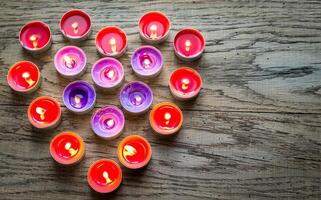 Burning candles arranged in the shape of heart photo