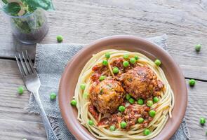 Turkey meatballs with pasta and fresh peas photo