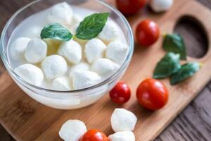 Bowl of Bocconcini mozzarella with fresh cherry tomatoes photo