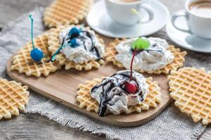 Belgian waffles with whipped cream and chocolate topping photo