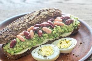 Sandwich with smashed avocado and kidney beans photo