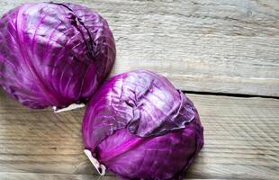 Two red cabbages on the wooden background photo