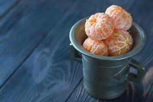 Peeled tangerines in the vintage cup photo