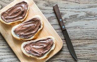 Slices of baguette with chocolate cream photo