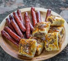 Grilled sausages and sausage rolls photo