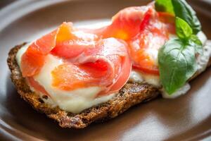 Sandwich with trout, mozzarella and tomatoes photo