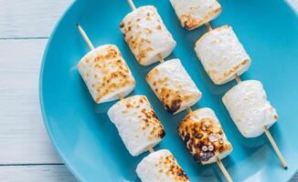 Marshmallow skewers on the plate photo