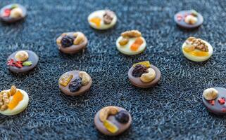 Swiss chocolate candies with nuts and dried fruits photo