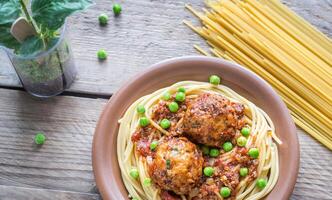 Turkey meatballs with pasta and fresh peas photo