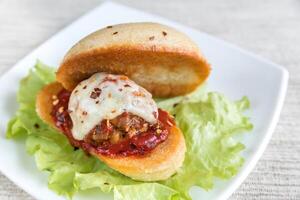 Sandwich with meatball in tomato sauce and mozzarella photo