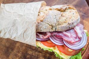 Sandwich with ham, cheese and fresh vegetables photo