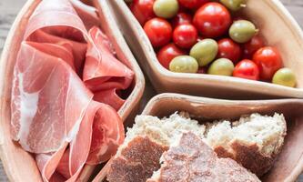 Jamon with bread and cherry tomatoes photo