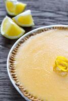 Lemon tart on the wooden background photo