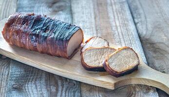 Pork loin wrapped in bacon photo