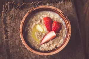 Bowl of oats with fresh strawberries photo