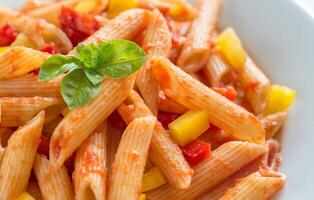 Penne with tomato sauce and fresh pepper photo