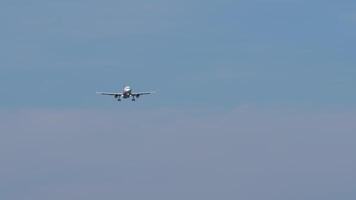 Long shot of a jet aircraft approaching to land. Airliner descending. Airplane in the sky. Plane flying video