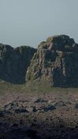 A large rock outcropping in the middle of a field video