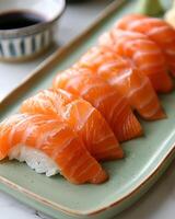 AI generated Salmon sushi is neatly arranged on a light green plate, The table used is white table top photo