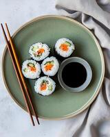 AI generated Futomaki sushi on a green plate with shoyuu in a small bowl, there are two chopsticks and a cloth, The table used is bright cement photo