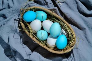 Easter composition in blue shades. Painted eggs in a basket. photo