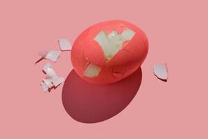 Cracked pink Easter egg on a pink background. photo