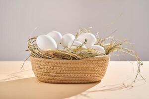 Wicker basket with farm natural white eggs. photo