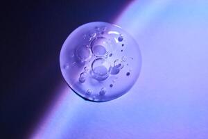 A drop of serum under ultraviolet light. photo