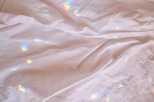 Rainbow highlights on a cotton sheet. photo