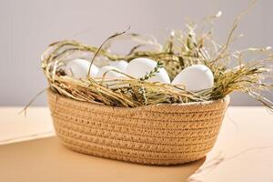 Wicker basket with farm natural white eggs. photo