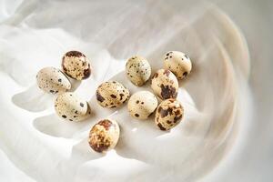 Quail eggs on a white linen towel close-up. photo