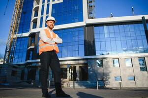 portrait of a young architect or engineer on a construction site photo