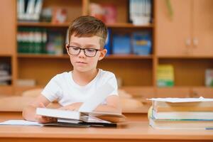 School boy in classroom at lesson photo