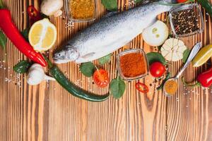 fresh trout with spices and seasonings top view, flat lay photo