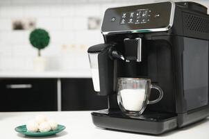 Home professional coffee machine with cappuccino cup. coffee machine latte macchiato cappuccino milk foam prepare concept photo