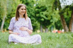 Pregnant woman resting in the park photo