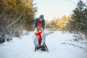 Two young people sliding on a sled photo