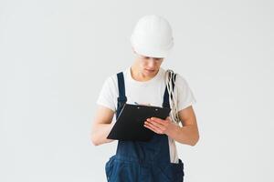 Full length of mid adult service man taking notes over white background photo