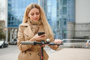 Young woman on electro scooter in city. photo