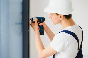 window fitter using cordless drill photo