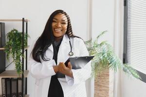 An African American female medical doctor with a stethoscope in hospital. photo