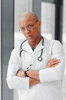 African American man male hospital doctor in white coat with stethoscope. photo