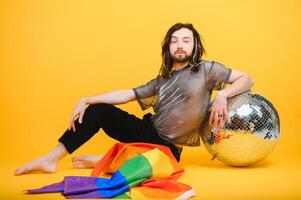 Young gay man is standing in the studio and posing for a camera. photo